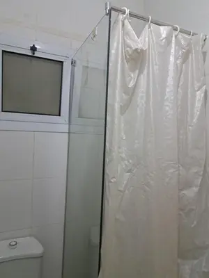 a bathroom with a shower curtain and a toilet at Desert Bearl compound in Hurghada