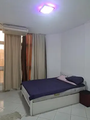 a bedroom with a bed in a room with a window at Desert Bearl compound in Hurghada