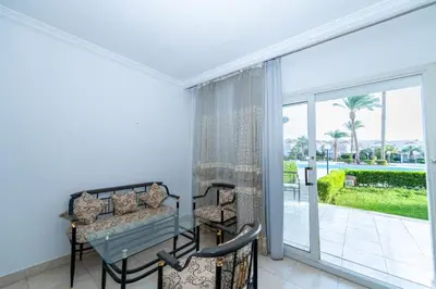 a living room with a couch and a large window at Hurghada Khaligeya village in Hurghada