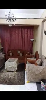 a living room with a couch and a red curtain at Aswan Lovely Apartment in Aswan