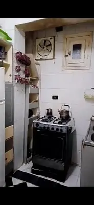 a kitchen with a stove with two pots on it at Aswan Lovely Apartment in Aswan