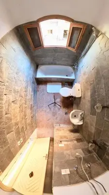 a bathroom with a toilet and a sink and a window at Sunset Haven in Luxor