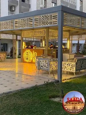 a pavilion with a table and chairs on a patio at Fanadir bay compound in Hurghada