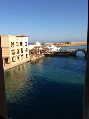 a view of a river with buildings and a bridge at Cozy studio with a view in port ghalib in Marsa Alam