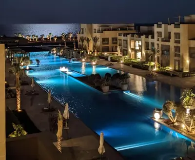 an image of a pool at night at Homestyle & Summery 1BDR Mangroovy Free Beach Pool in Hurghada