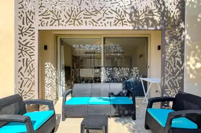 a table and chairs in front of a building at Homestyle & Summery 1BDR Mangroovy Free Beach Pool in Hurghada