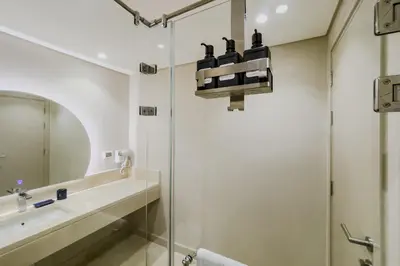 a bathroom with a shower and a sink at Homestyle & Summery 1BDR Mangroovy Free Beach Pool in Hurghada