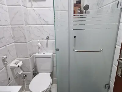 a white bathroom with a toilet and a shower at Tiba View in Hurghada