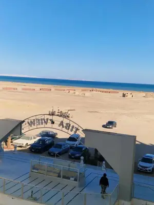 a view of a beach with cars parked in a parking lot at Tiba View in Hurghada