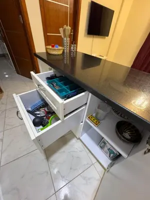 a kitchen counter with an open drawer under a table at Tiba View in Hurghada