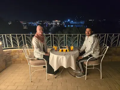 two men sitting at a table at night at Blue Lotus House in Luxor