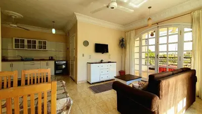 a living room with a couch and a kitchen at Blue Lotus House in Luxor