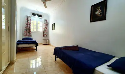 a bedroom with two beds and a window at Blue Lotus House in Luxor