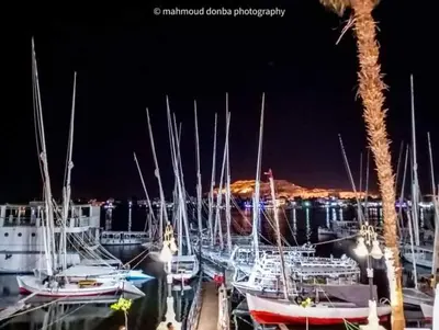 a group of boats docked in a marina at night at البعيرات in Al Karnak
