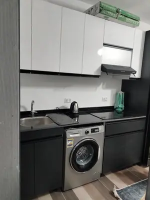 a kitchen with a washing machine and a sink at Porto Ghalib in Port Ghalib