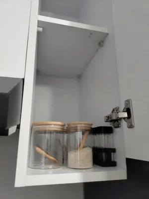 a kitchen shelf with jars and spices on it at Porto Ghalib in Port Ghalib