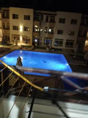 a large swimming pool in a building at night at Porto Ghalib in Port Ghalib