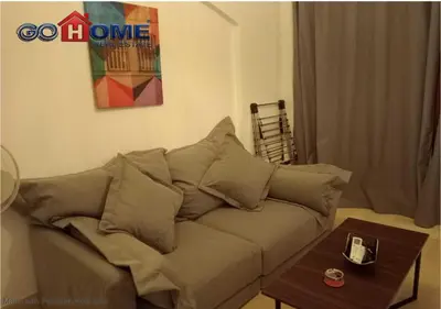 a couch in a living room with a table at Comfortable 1 Bedroom at Sabina El-Gouna Y160 in Hurghada