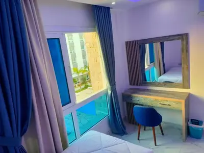 a bedroom with a mirror and a desk and a window at Fanadir Bay Compound in Hurghada