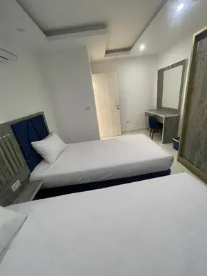 a bedroom with a bed and a mirror and a desk at Fanadir Bay Compound in Hurghada