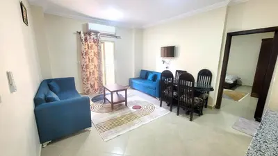 a living room with a blue couch and a table at Andalusia Palace in Hurghada