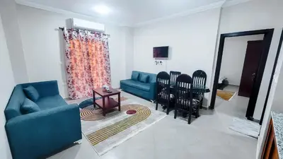 a living room with a blue couch and chairs at Andalusia Palace in Hurghada