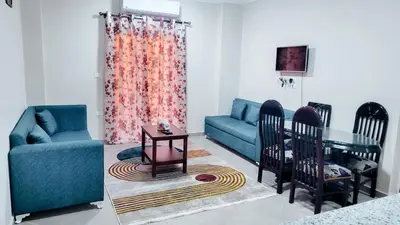a living room with a couch and a table and chairs at Andalusia Palace in Hurghada