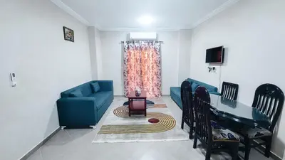 a living room with a blue couch and a table at Andalusia Palace in Hurghada