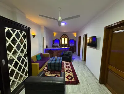 a living room with a couch and a table at The Highlander in Al Karnak
