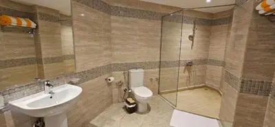 a bathroom with a sink and a toilet and a shower at Elhambra First Avenue in Hurghada