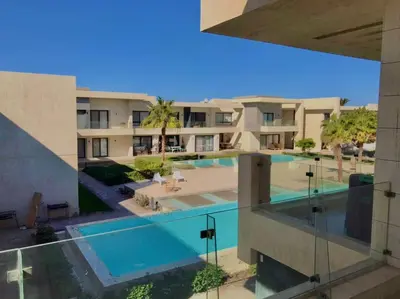 a view of a building with a swimming pool at Stunning 1-Bedroom in G Cribs in Hurghada