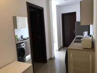 a kitchen with a stove and a washing machine at Stunning 1-Bedroom in G Cribs in Hurghada