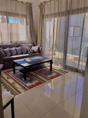 a living room with a couch and a coffee table at Stunning 1-Bedroom in G Cribs in Hurghada