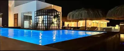 a large blue swimming pool at night with an umbrella at Imperial Resort Hurghada Studio pool view in Hurghada