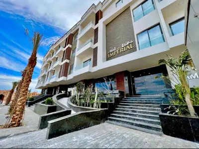 a hotel with stairs in front of a building at Imperial Resort Hurghada Studio pool view in Hurghada