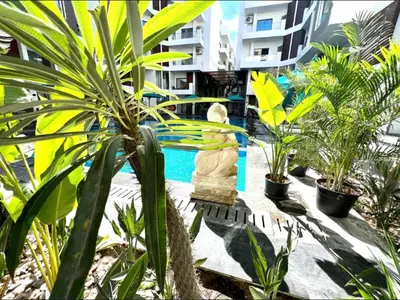 a statue next to a swimming pool with plants at Imperial Resort Hurghada Studio pool view in Hurghada