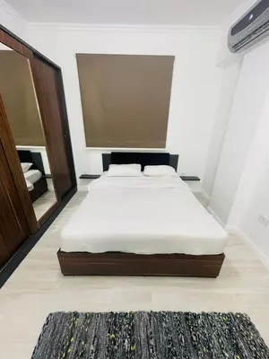 a bedroom with a bed and a mirror at Luxurious One Bedroom Apartment in Hurghada