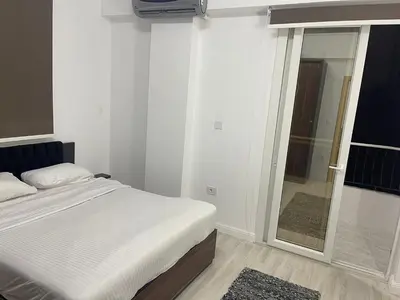 a bedroom with a bed and a large mirror at Luxurious One Bedroom Apartment in Hurghada