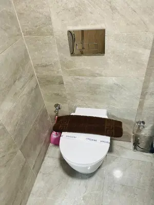 a bathroom with a toilet in a tiled room at Luxurious One Bedroom Apartment in Hurghada