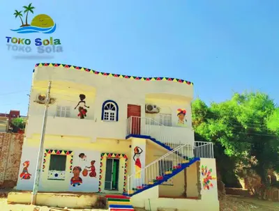 a small house with a staircase in front of it at Toko Sola in Jazīrat Suhayl