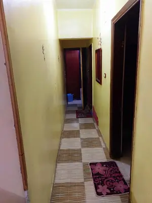 an empty hallway with a tile floor in a house at Mahmoud's House in Al Manshīyah