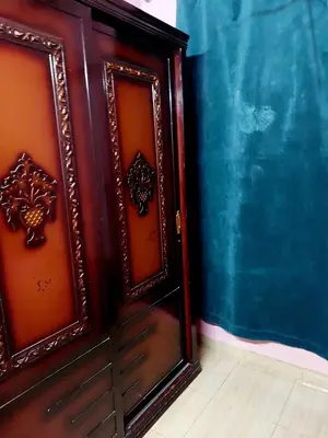 a close up of a wooden door in a room at Mahmoud's House in Al Manshīyah