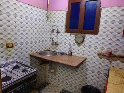 a kitchen with a sink and a stove at Mahmoud's House in Al Manshīyah