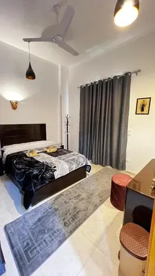 a bedroom with a bed and a ceiling fan at Seti house in Luxor
