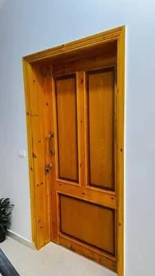 a wooden door in the corner of a room at Seti house in Luxor