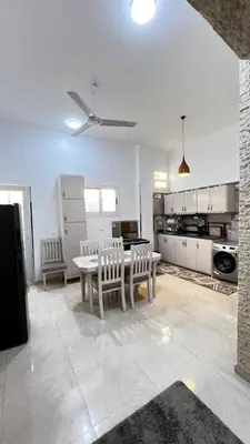 a kitchen with a table and chairs in a room at Seti house in Luxor