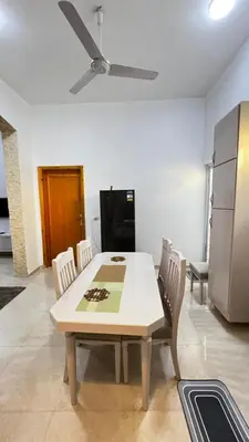 a kitchen with a table and chairs and a refrigerator at Seti house in Luxor