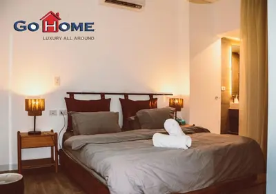 a bedroom with a bed with a white towel on it at Cozy 3BR at Sholan with Private Heated Pool El-Gouna in Hurghada