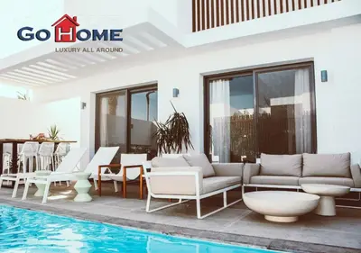 a villa with a swimming pool next to a house at Cozy 3BR at Sholan with Private Heated Pool El-Gouna in Hurghada