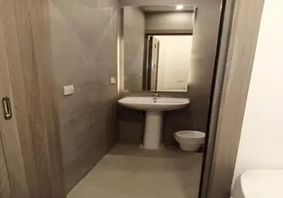 a small bathroom with a sink and a toilet at Cozy 3BR at Sholan with Private Heated Pool El-Gouna in Hurghada